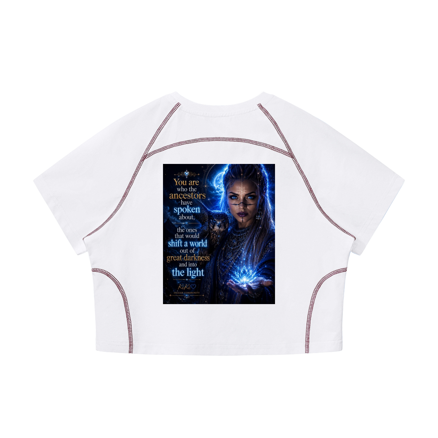 A white short-sleeve crop top with contrasting brown contrast stitching and a large graphic print on the front featuring a fantasy character with blue energy and text.