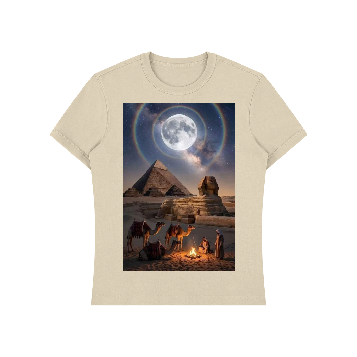 A beige short-sleeve crewneck t-shirt featuring a large rectangular graphic print on the front. The graphic depicts a desert night scene with the pyramids and Sphinx under a large moon with a rainbow halo, with camels and figures near a campfire in the foreground.