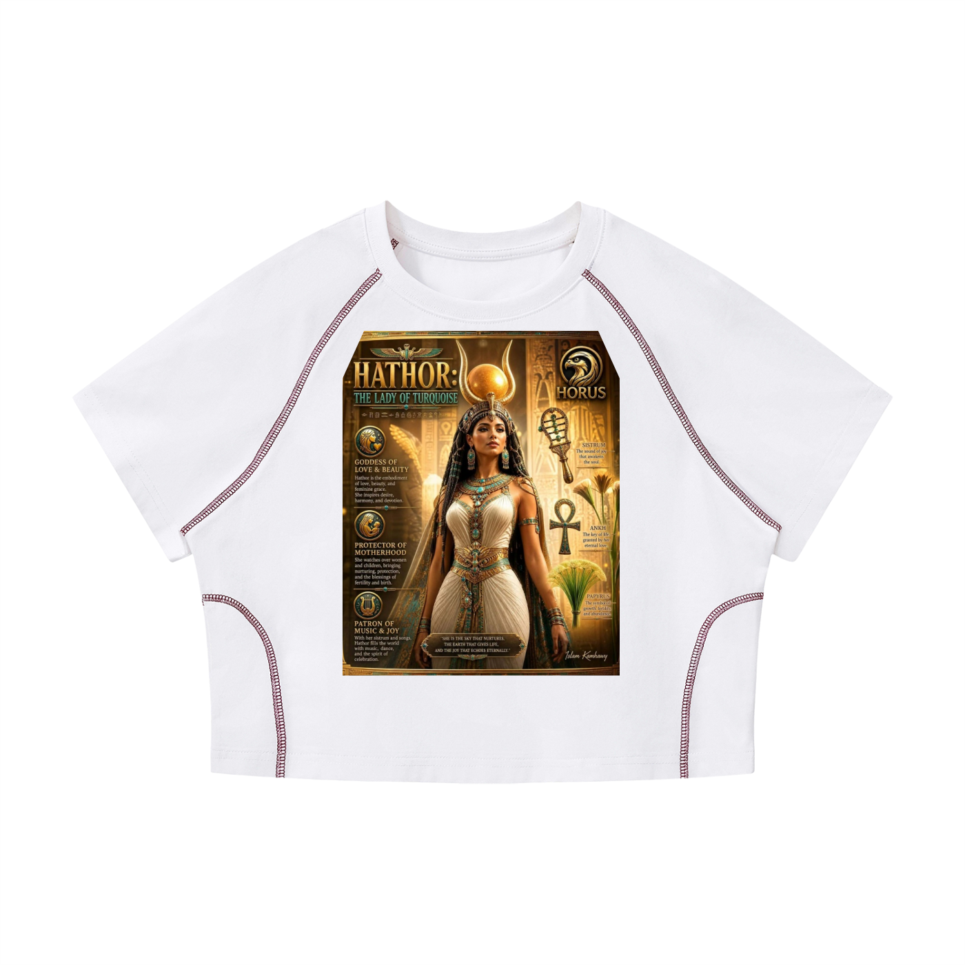 A white short-sleeve crop top with raglan sleeves and side stitching, featuring a large graphic print on the front depicting an Egyptian-themed illustration labeled 'Hathor' and 'MORPHS'.