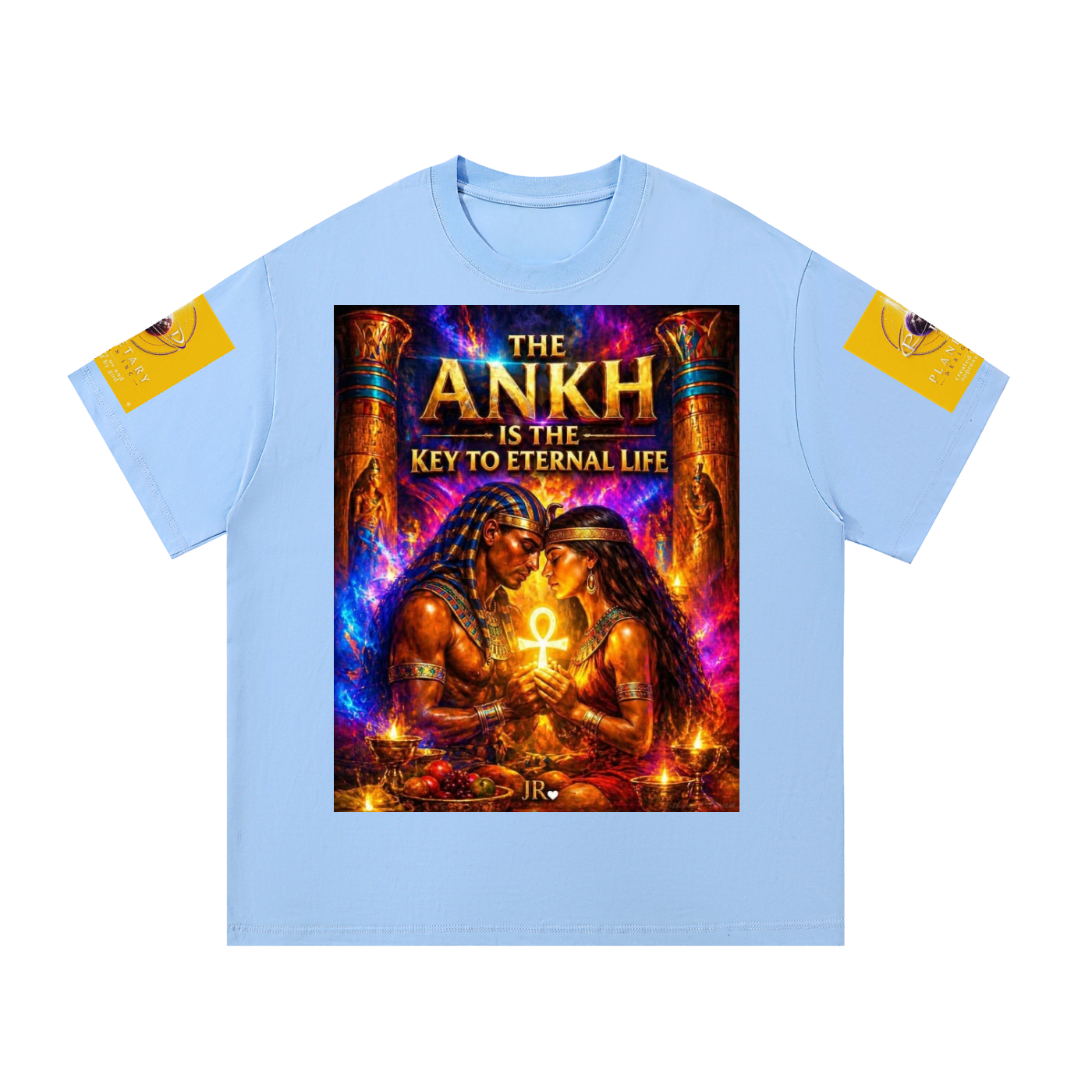 A light blue crewneck t-shirt featuring a large, vibrant graphic print on the front depicting two ancient Egyptians holding an Ankh symbol, with the text 'THE ANKH IS THE KEY TO ETERNAL LIFE'. The sleeves have yellow patches on the upper left and right sleeves containing circular black and white eye illustrations.