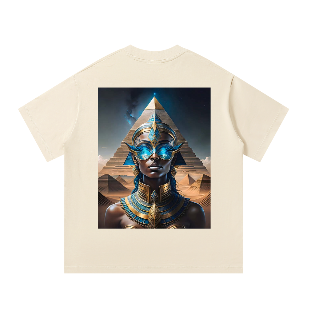 Beige t-shirt with a graphic of an Egyptian-themed design featuring a person in front of pyramids.