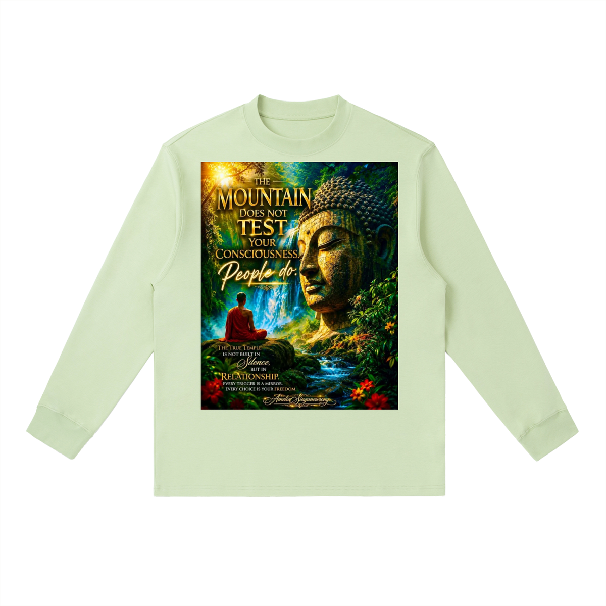 A light sage green long-sleeve t-shirt with a large, colorful graphic print on the front featuring a Buddha statue, a meditating figure, and the text 'THE MOUNTAIN DOES NOT TEST YOUR CONCEPTUALINESS People do'.