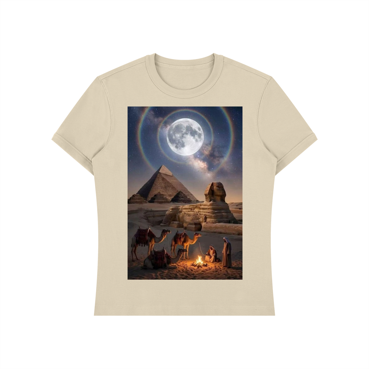 A beige short-sleeve crewneck t-shirt featuring a large rectangular graphic print on the front. The graphic depicts a desert night scene with the pyramids and Sphinx under a large moon with a rainbow halo, with camels and figures near a campfire in the foreground.