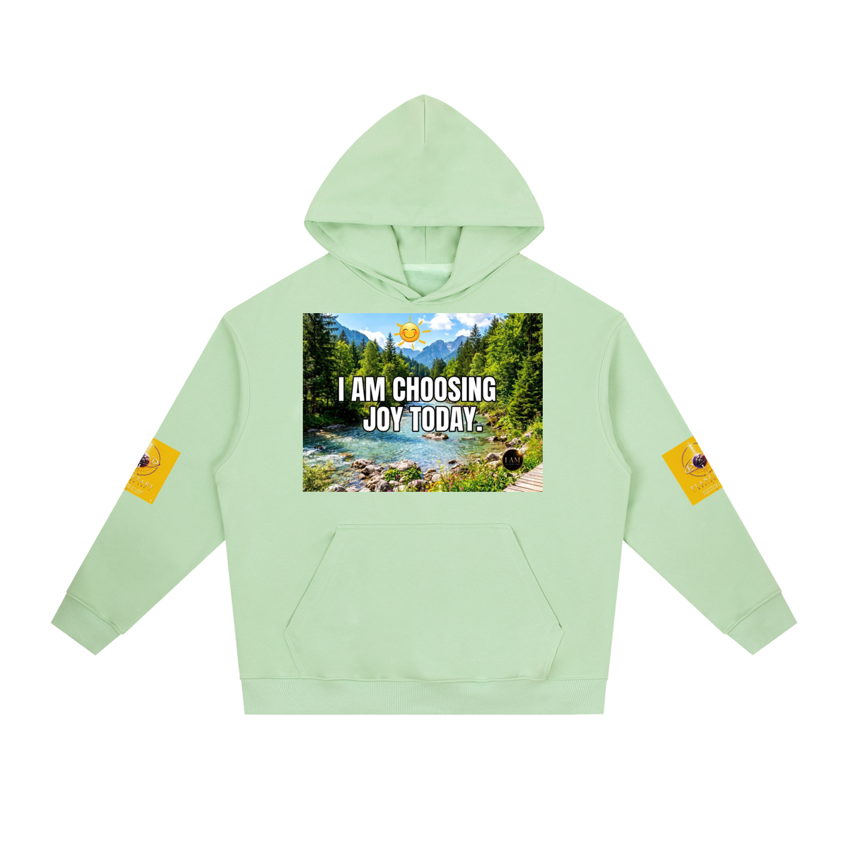 A light mint green pullover hoodie with a front graphic showing a mountain river scene and the text 'I AM CHOOSING JOY TODAY.' White text is overlaid on the image.