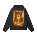 A black pullover hoodie featuring a large rectangular graphic print on the front with a glowing golden Ankh symbol over a fiery, hieroglyphic-style background. The hoodie is displayed flat against a solid white background.