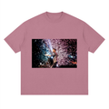 Pink t-shirt with a graphic of a person holding a sparkler against a fireworks background.