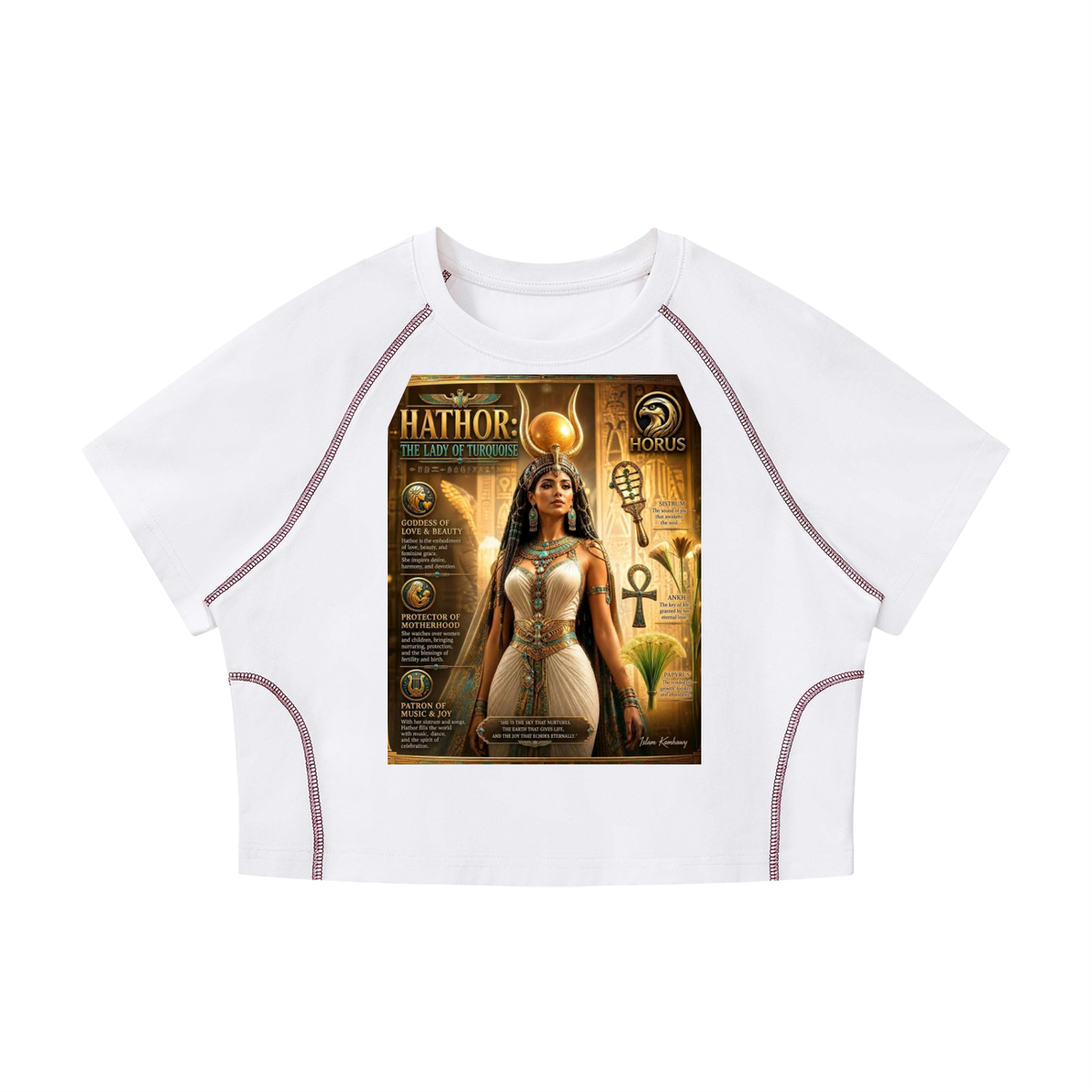 A white short-sleeve crop top with raglan sleeves and side stitching, featuring a large graphic print on the front depicting an Egyptian-themed illustration labeled 'Hathor' and 'MORPHS'.