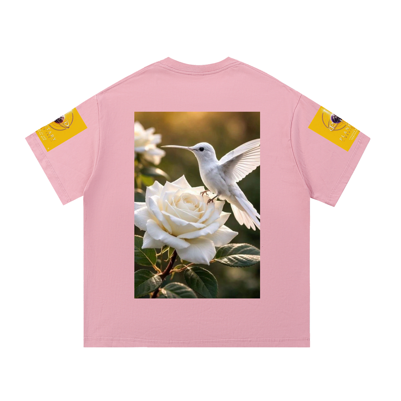 A light pink short-sleeve t-shirt shown flat against a white background. The back of the shirt features a large rectangular graphic print of a white hummingbird perched on a white rose.