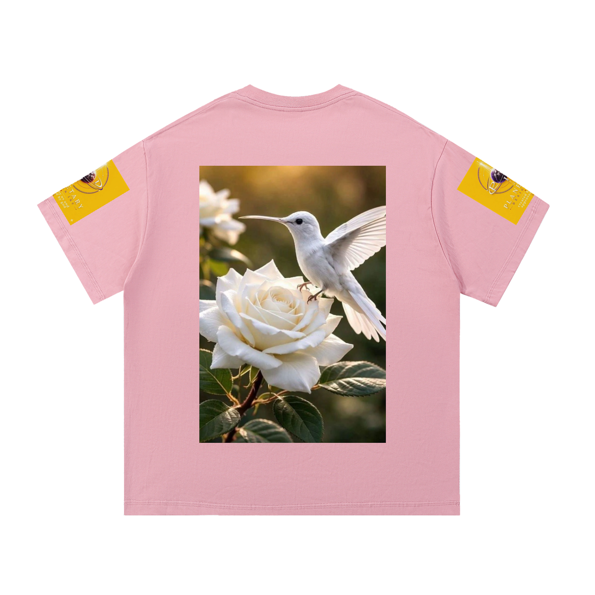 A light pink short-sleeve t-shirt shown flat against a white background. The back of the shirt features a large rectangular graphic print of a white hummingbird perched on a white rose.